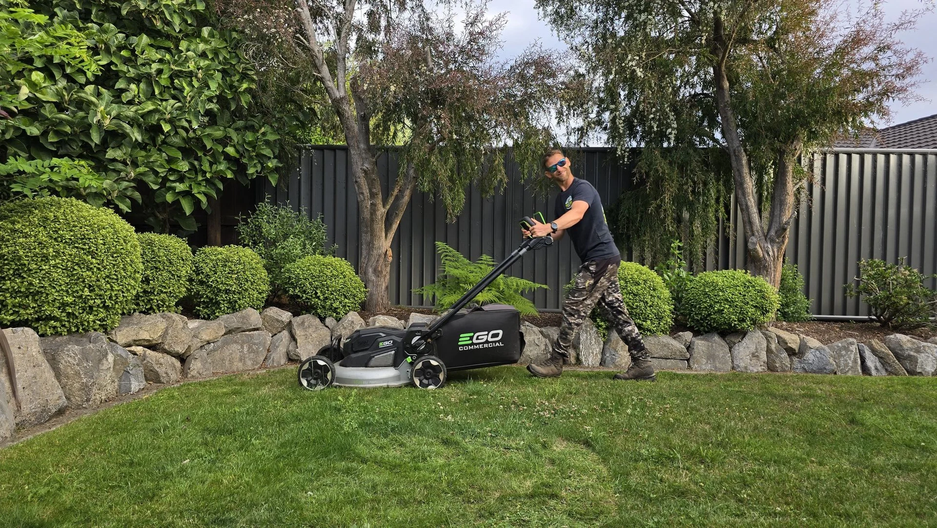 Mark Bannan mowing a lawn in Nelson with a commercial EGO mower
